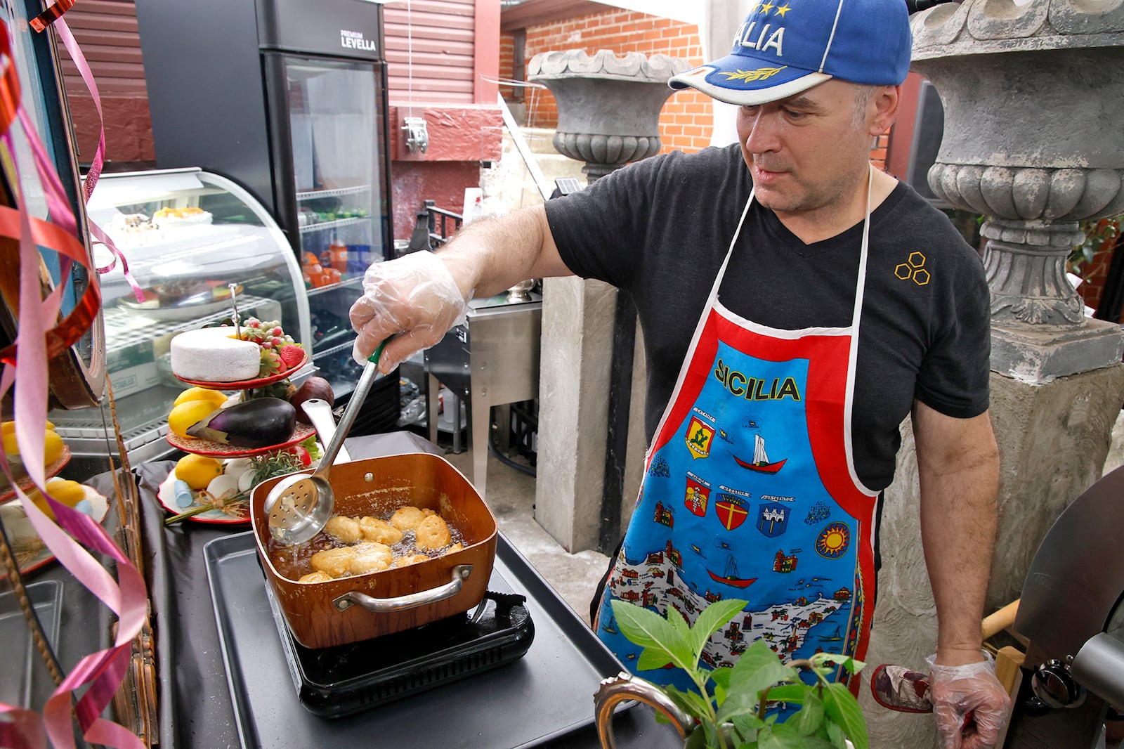 Tom Thompson, owner of Eatly, makes some zeppoli Thursday, May 23, 2024. BILL LACKEY/STAFF