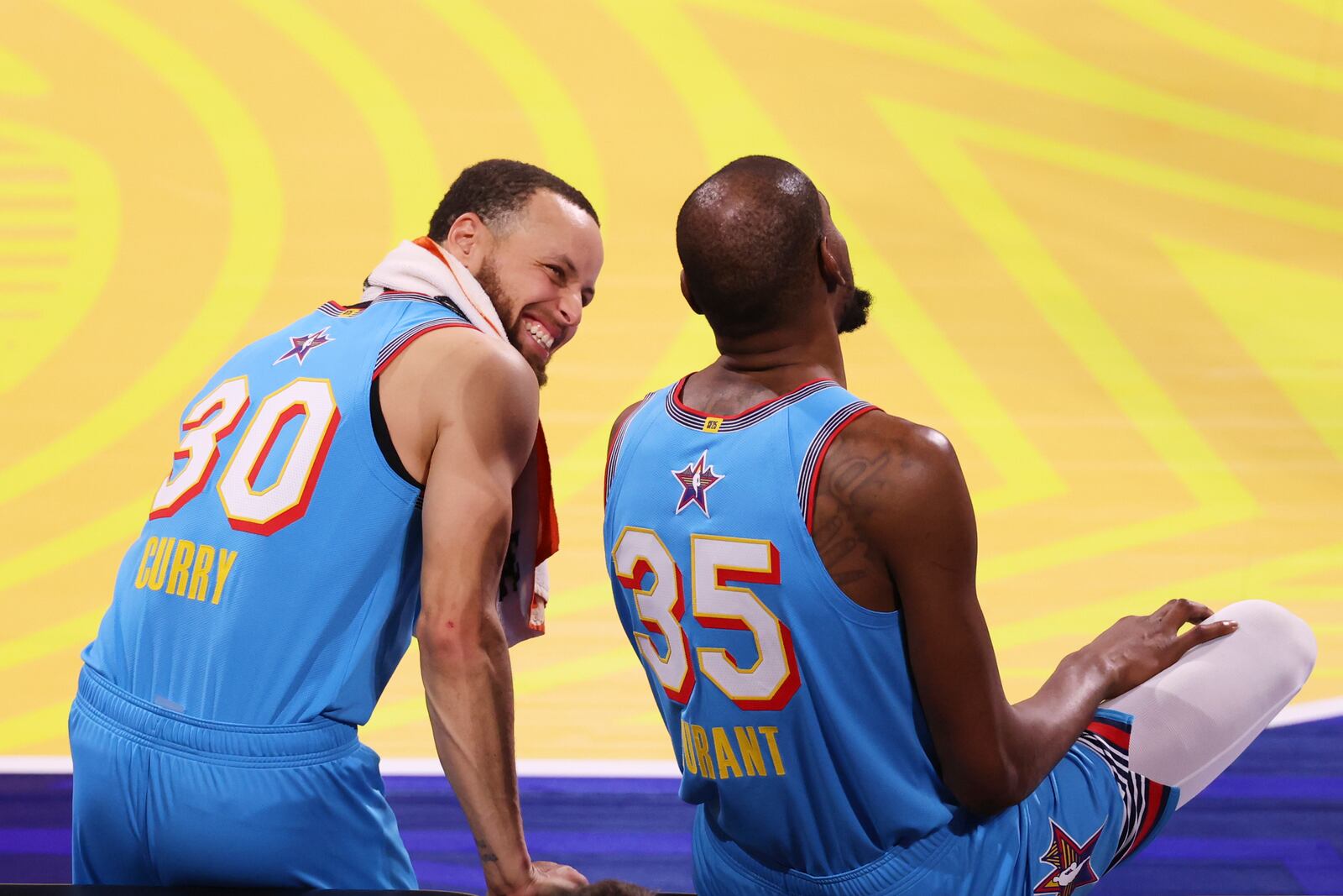 Golden State Warriors guard Stephen Curry talks to Phoenix Suns forward Kevin Durant during the NBA All-Star basketball game Sunday, Feb. 16, 2025, in San Francisco. (AP Photo/Jed Jacobsohn)