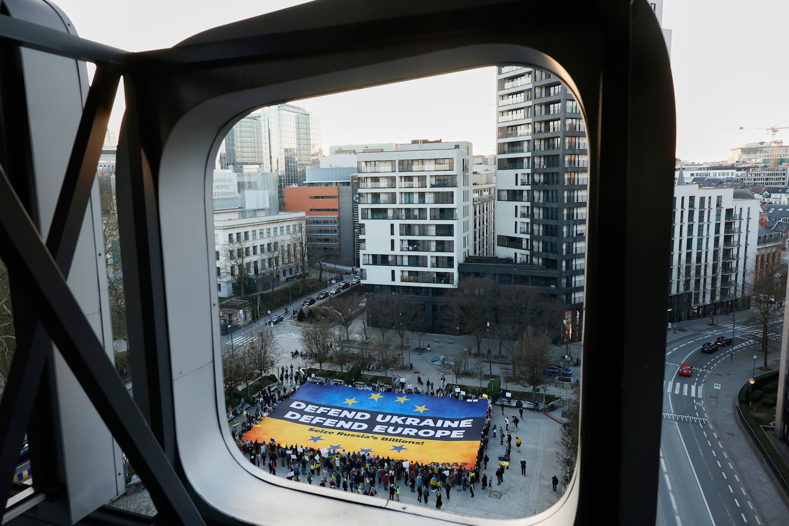 Activists unfurl a large banner in support of Ukraine outside the European Council building ahead of an EU summit in Brussels, Belgium, Wednesday, March 5, 2025. (AP Photo/Omar Havana)