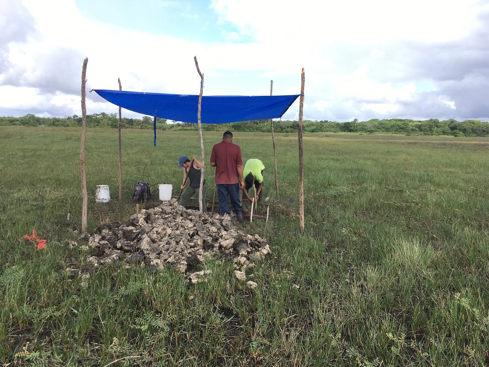 This 2019 photo provided by the Belize River East Archaeology project, researchers excavate sediment that will be sequenced to help them date the evidence of a large-scale pre-Columbian fish-trapping facility in Belize. (Belize River East Archaeology project via AP)