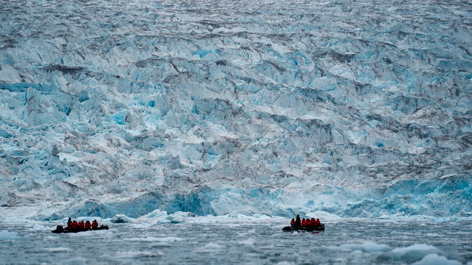 FILE - Two groups from the Poseidon Expeditions tour company look at a glacier in the Scoresby Sund, on Sept. 7, 2023, in Greenland. (AP Photo/Chris Szagola, File)