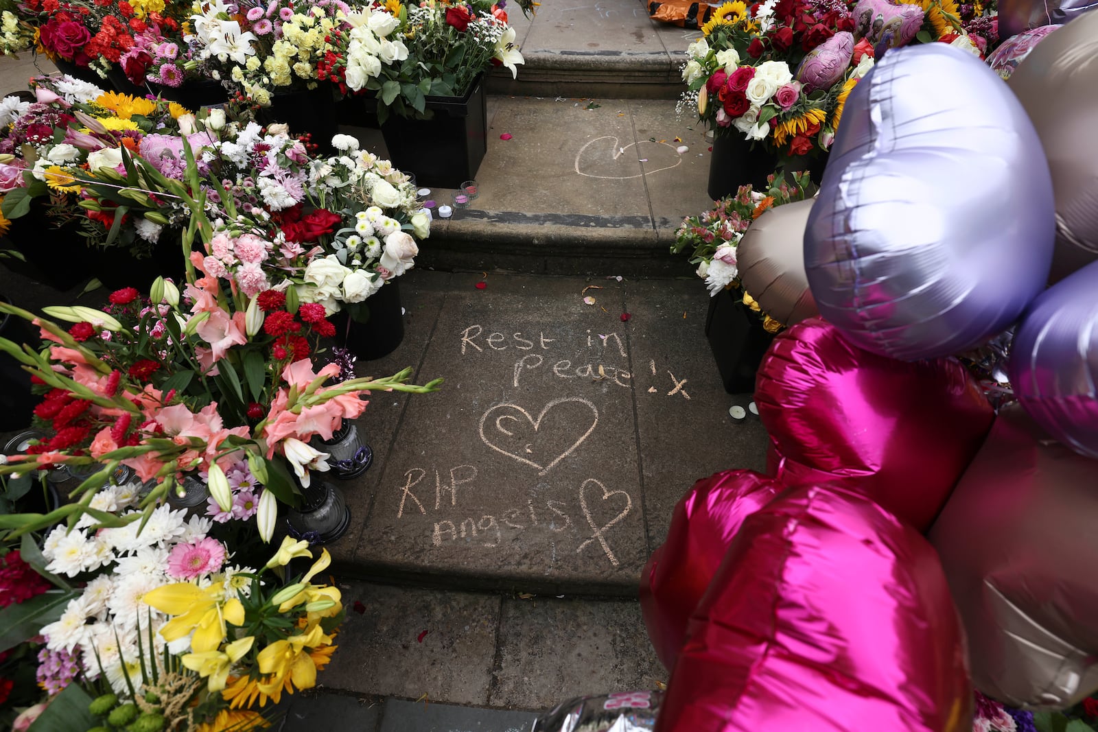 FILE - Tributes are seen outside the Town Hall in Southport, England, Aug. 5, 2024 after three young girls were killed in a knife attack at a Taylor Swift-themed holiday club the week before. (AP Photo/Darren Staples, File)