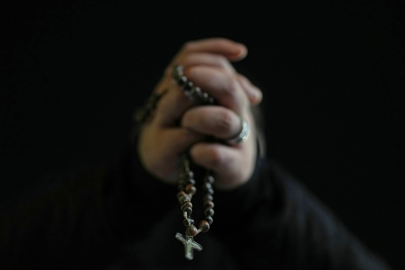 A Catholic worshipper holds a rosary prior a prayer of the Rosary for Pope Francis in St. Peter's Square at The Vatican, Sunday, March 9, 2025. (AP Photo/Francisco Seco)