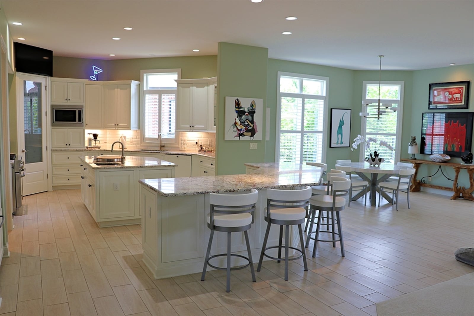 Woodgrain, ceramic-tile flooring fills the foyer and wraps around the great room space into the kitchen and breakfast room.