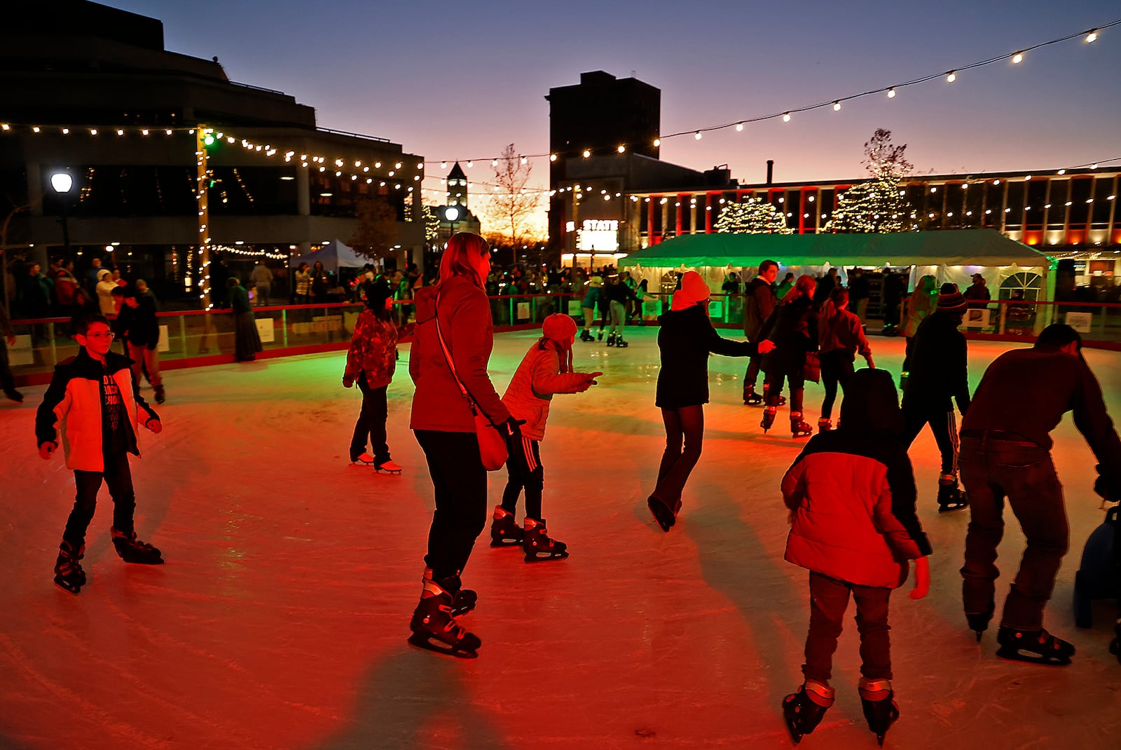 The Holiday in the City festivities got started Friday evening, Nov. 25, 2022 with the arrival of Santa, who lit the Holiday Tree from a Springfield Fire Division aerial truck. The outdoor ice skating rink was officially opened and holiday characters were woundering the downtown area. The Grand Illumination kicked off a month of activities planned for downtown Springfield. BILL LACKEY/STAFF