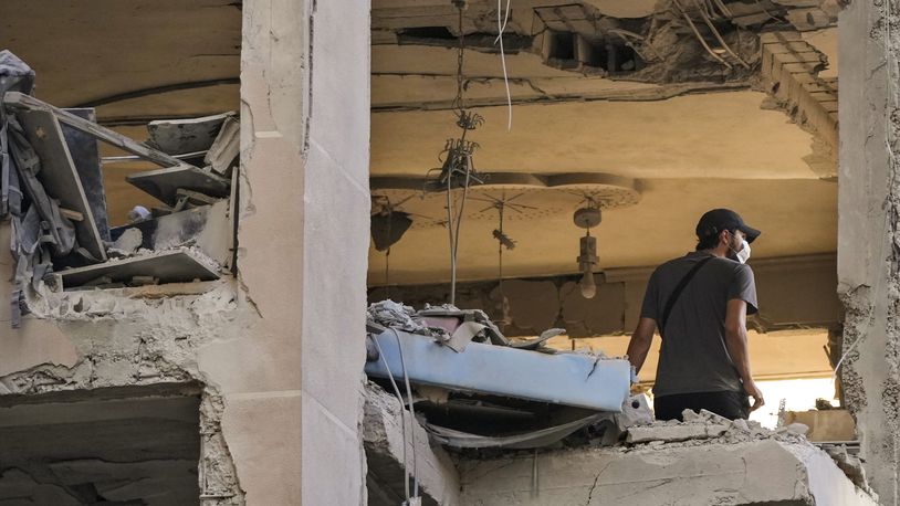 A resident checks an apartment that was hit by an Israeli airstrike in Beirut's southern suburbs, Thursday, Sept. 26, 2024. (AP Photo/Hassan Ammar)