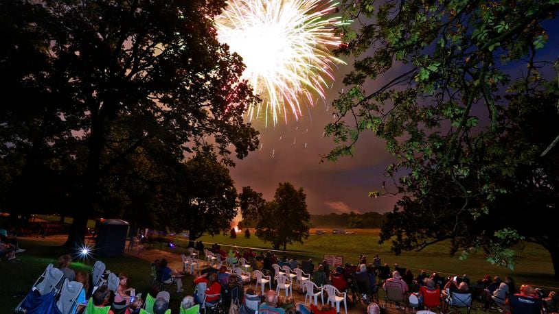 The rain stopped just in time for the Buck Creek Boom fireworks show to go on Monday, July 3, 2023 in Springfield. Spectators lined the shore of Buck Creek to watch the annual show put on by the National Trail Parks and Recreation District. BILL LACKEY/STAFF