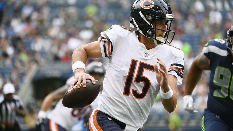 Chicago Bears quarterback Trevor Siemian (15) scrambles with the ball during the first half of a preseason NFL football game against the Seattle Seahawks, Thursday, Aug. 18, 2022, in Seattle. (AP Photo/Caean Couto)