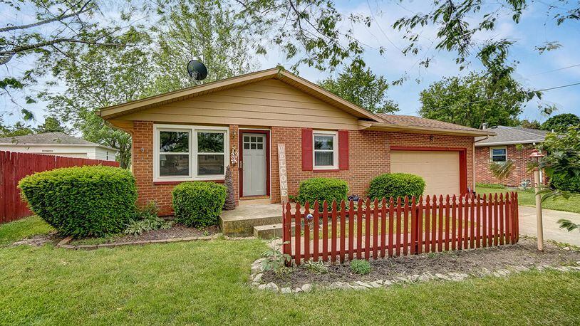 The front of this brick ranch home features a wood, decorative fence, a new front door and an attached, 2-car garage. The 3-bedroom home offers about 1,125 sq. ft. of living space and a full, partially finished basement. CONTRIBUTED PHOTO