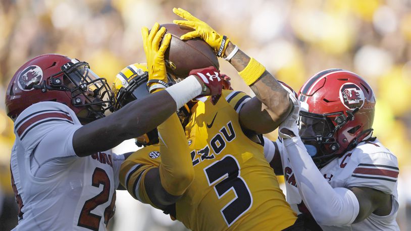 FILE - Missouri wide receiver Luther Burden III (3) catches a pass for a touchdown as South Carolina defensive backs Jalon Kilgore (24) and DQ Smith (1) defend during the first half of an NCAA college football game, Saturday, Oct. 21, 2023 in Columbia, Mo. (AP Photo/Colin E Braley, File)