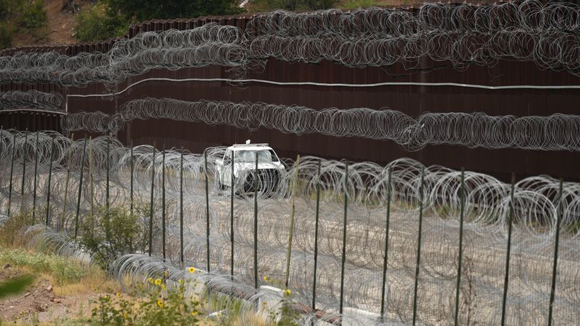 FILE - A vehicle drives along the U.S. side of the US-Mexico border wall in Nogales, Ariz. on Tuesday, June 25, 2024. (AP Photo/Jae C. Hong, Pool)