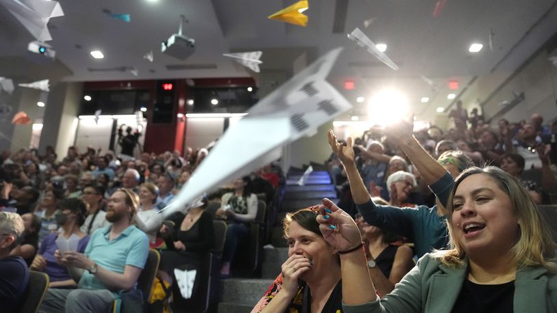 People in the audience throw paper airplanes toward the stage during a performance at the Ig Nobel Prize ceremony at Massachusetts Institute of Technology in Cambridge, Mass., Thursday, Sept. 12, 2024. (AP Photo/Steven Senne)