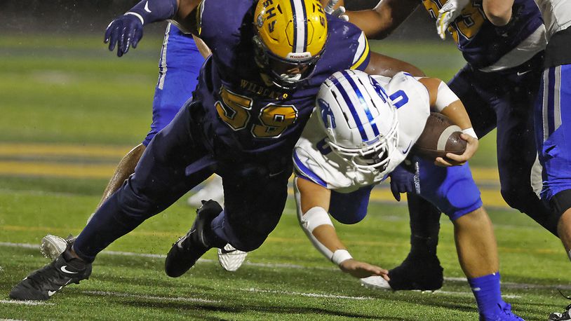 Springboro's Mattias Brunicardi is tackled by Springfield's Royce Rogers during Friday night's game in Springfield. BILL LACKEY/STAFF