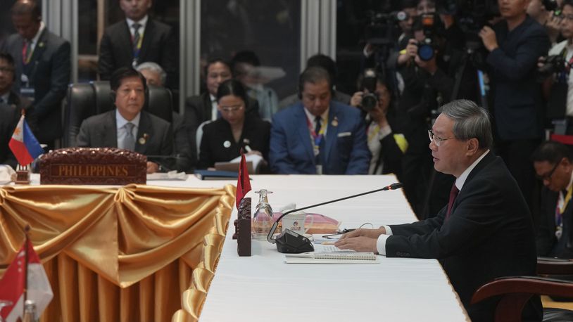 Chinese Premier Li Qiang, right, delivers his opening remarks as Philippine's President Ferdinand Marcos Jr., front left, listens during the 27th Association of Southeast Asian Nations (ASEAN)-China Summit in Vientiane, Laos, Thursday, Oct. 10, 2024. (AP Photo/Dita Alangkara)