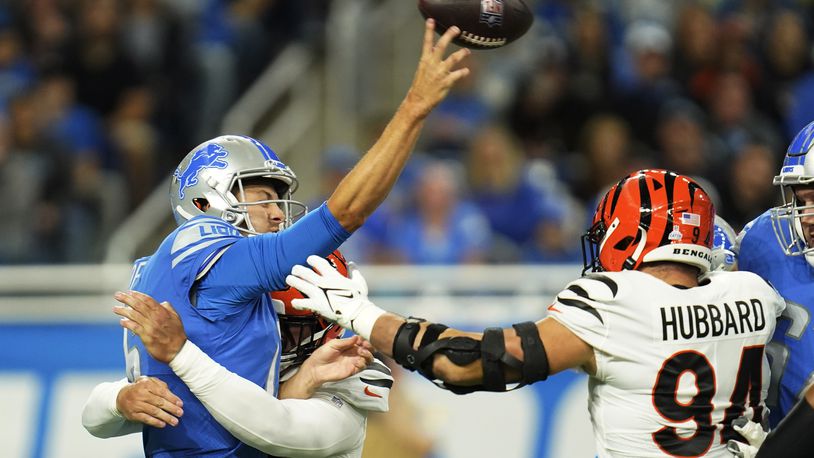 Detroit Lions quarterback Jared Goff is pressured by Cincinnati Bengals defensive end Trey Hendrickson during the first half of an NFL football game, Sunday, Oct. 17, 2021, in Detroit. (AP Photo/Paul Sancya)
