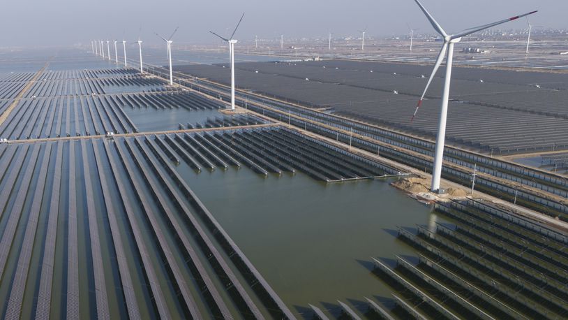 Wind turbines dot the coast line along a giant solar farm near Weifang in eastern China's Shandong province on March 22, 2024. China's Commerce Ministry has announced it will launch an investigation into whether unfair trade practices were adopted by the European Union in its probe of Chinese companies. It said Wednesday, July 10, 2024 the investigation will focus on wind power, photovoltaics, security equipment and others. (AP Photo/Ng Han Guan)
