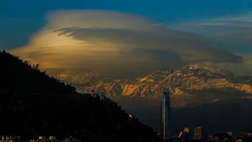 FILE - Clouds hover over the Andes Mountains in Santiago, Chile, June 19, 2024. (AP Photo/Esteban Felix, File)