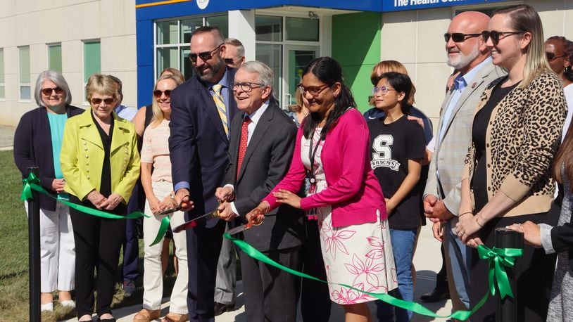 Springfield City Schools Superintendent Bob Hill, Ohio Gov. Mike DeWine and Rocking Horse Community Health Center CEO Dr. Yamini Teegala cut the ribbon at Springfield's new School Based Health Center Monday, Aug. 12, 2024. JESSICA OROZCO/STAFF